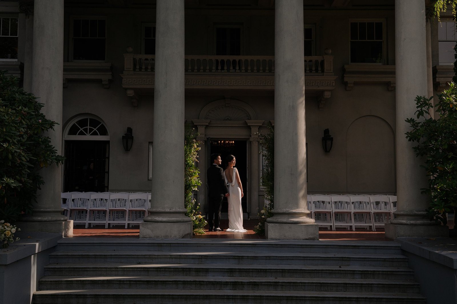 Intimate wedding couple portrait along the Corinthian peristyle columns and Italianate terrace of Hycroft Manor in Vancouver BC